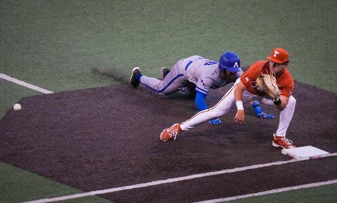 Texas Longhorns infielder Casey Borba (31) catches a pick-off attempt as UT Arlington Mavericks catcher Parker Airhart (10) slides back to first base in the fourth inning of the Longhorns' game against the UT Arlington Mavericks at UFCU Disch-Falk Field, Tuesday, April 23, 2024. Rodriguez is acting head coach while David Pierce is suspended.