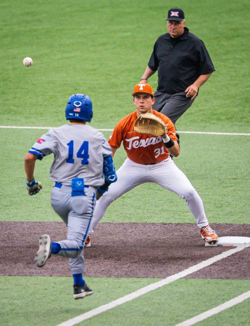Texas Longhorns infielder Casey Borba (31) catches the ball at first base to get UT Arlington Mavericks outfielder Jacskon Hill (14) out in the first inning of the Texas Longhorns' game against the Mavericks at UFCU Disch-Falk Field, Tuesday, April 23, 2024. Rodriguez is acting head coach while David Pierce is suspended.